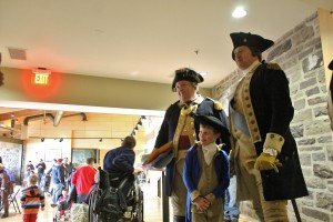 John Godzieba, portraying George Washington (left), with a child and a fellow reenactor. Credit: Tom Sofield/NewtownPANow.com