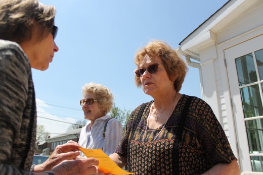 Tara Grunde McLaughlin Mary Gonzalez talks with voter Edith Gowin outside the Newtown Fire Station. In the background, Jane Scopelite talked with Tara Grunde-McLaughlin. Credit: Tom Sofield/NewtownPANow.com