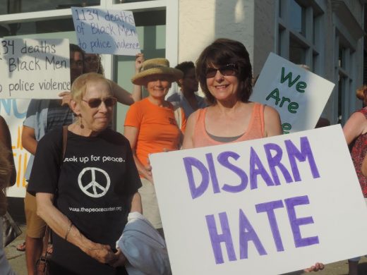 Natalie Kaye, left, of the Interfaith Community, and Barbara Simmons of The Peace Center, stand together in solidarity against racism. Credit: Petra Chesner Schlatter/NewtownPANow.com 