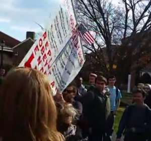 A student ripping down the protestor's sign. Credit: Ryan W Russell/ Facebook screengrab