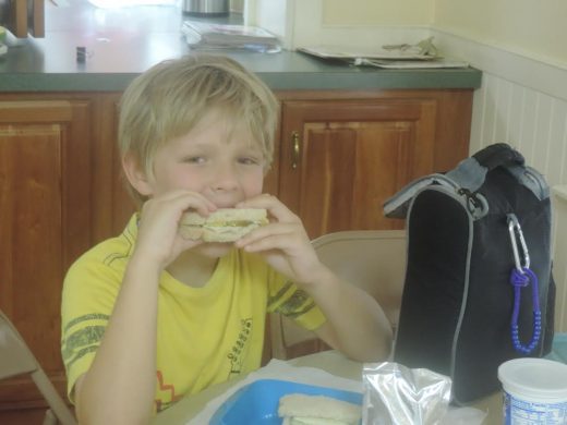 Conner Kuryluk enjoys his turkey and cheese sandwich at Peace Camp. The theme of the camp is “Learning Emotions,” inspired by “Inside Out,” a popular Disney movie. Credit: Petra Chesner Schlatter